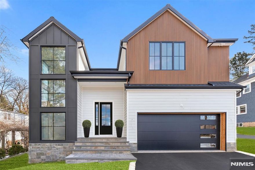 Experience modern luxury in this new construction transitional home in the sought after Maugham section of Tenafly! Designed for elegance and functionality, this 6 bed, 5 bath masterpiece fts an open floor plan, soaring 10 ft ceilings on 1st flr, and an abundance of natural light. The gourmet kitchen boasts an expansive waterfall Island, Thermador appliances, dual dishwashers, quartz countertops, wet bar & a walk in pantry. A first fl bedrm, full bath & mudroom add convenience. Expansive floor to ceiling windows light up the staircase to the 2nd Fl featuring a serene master suite w/ 2 WICs & a spa like bath w/ soaking tub, double sinks, heated floors, & large rain shower. An En Suite Bedrm, 2 add'l bedrms w/ Jack & Jill Bath & Laundry Rm round out the 2nd fl. The fully finished basement includes a gym, theater, rec area, and guest suite. Smart home features include Nest thermostats, video doorbells & speakers throughout. 10 year builders warranty included. Close to top schools and NYC!