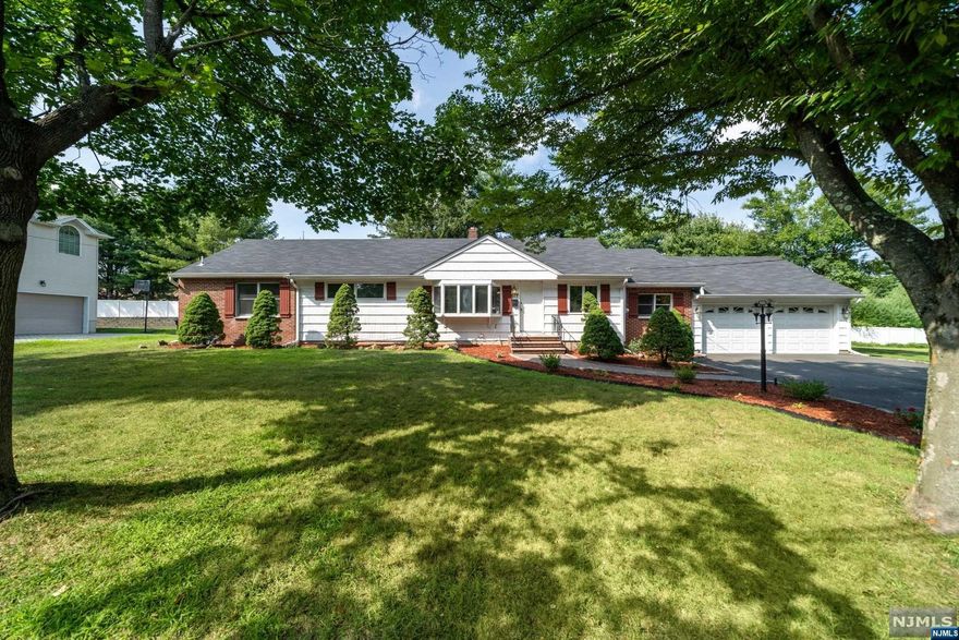 This impeccable 4-bedroom, 3-bathroom ranch is nestled in a prime Paramus location on a quiet cul-de-sac, offering .29 acres of serenity. The home boasts hardwood floors throughout, a modern eat-in kitchen, and a master bedroom with a walk-in closet and full bathroom. The full finished basement includes an additional room that can easily be converted into a 5th bedroom. Central air conditioning, attic storage with expansion potential, a newer roof and driveway, and a freshly painted interior add to the home's appeal. The professionally landscaped yard features a spacious deck, perfect for outdoor entertaining. Located close to shopping, public transportation, schools, churches, and the town pool, this home offers convenience and comfort in a sought-after neighborhood.