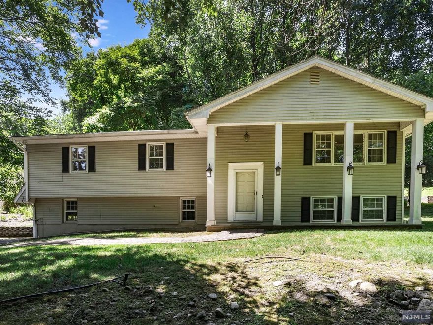 Bi-Level in North Haledon boasting great curb appeal! Entry foyer leads up to the first floor which offer spacious living room with large windows that give off great natural light. Open concept floor plan allows the living room to flow into the formal dining room. The kitchen offers granite countertops, custom cabinetry and separate dining area. Sliding glass doors lead to the rear deck. The primary bedroom is located just down the hall with en suite featuring stall shower and storage vanity. 2 additional bedrooms and full bathroom with tub shower and storage vanity to complete the first floor. The ground level offers family room with brick faced fireplace. There is also a bedroom on the ground floor that is currently being used as a den area. There is a half bathroom and laundry combo on the ground floor. The backyard offers large deck, which is perfect for outdoor entertaining during the warm summer months. Attached 2-car garage.