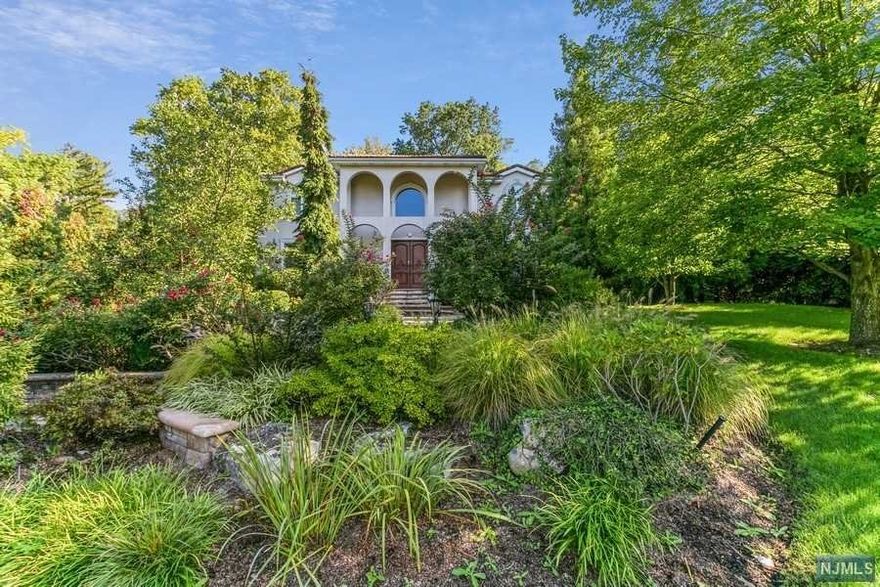 Stunning, contemporary Tenafly home sits atop the much desired East Hill, set on park-like landscaped property. Greeted by 20' grand entry foyer, dining room w/molding details leads to ultra modern kitchen, spacious and airy with 10' waterfall island and sun drenched informal dining area, flowing to family room w/gas fireplace and sliding doors lead to the entertaining patio area and high end pool w/ spa and waterfall. Formal living room, large office, bedroom w/ full bath, laundry room and powder, complete first floor. On second floor, primary suite w/ sitting room, 2 walk-in closets, spa-like bathroom & balcony overlooking yard. 4 large bedrooms w/ 2 J&J bathrooms also found on 2nd level. Full finished basement offers rec area, full bath, bedroom/gym w/ own entry. Gut renovated in 2017, many modern upgrades include full smart home system w/ alarm, indoor/outdoor speakers, thermostats, cameras, lights & doorbell, all controlled by cell phone, a full house generator and much more.