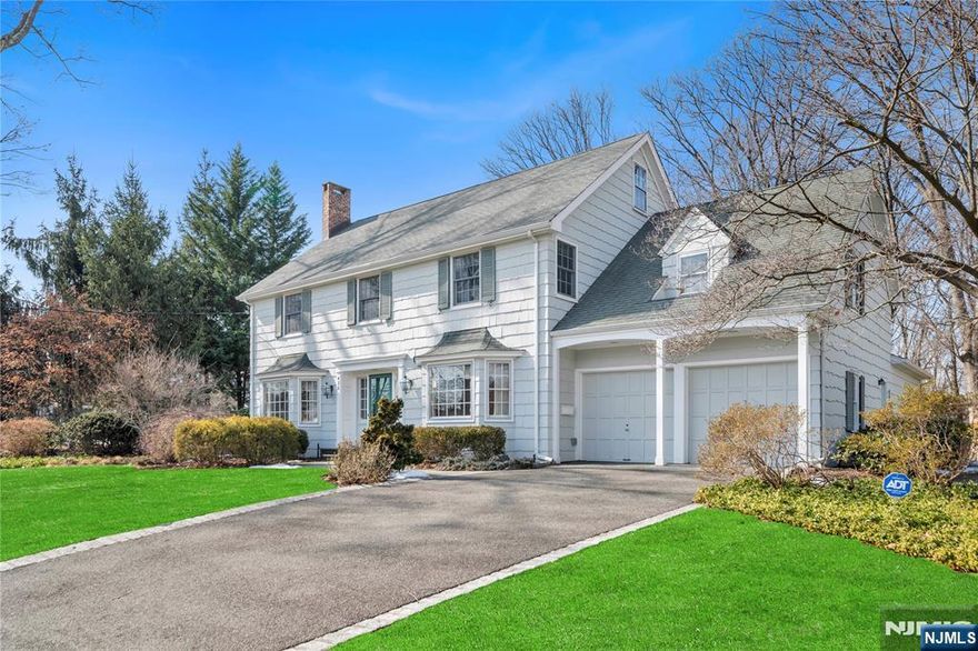 Welcome to this stunning center hall colonial on a breathtaking .9 AC lot w/ exquisite gardens, a charming patio, & sprawling green play yard, all surrounded by lush woods. The front-to-back center hallway is flanked by a banquet-sized dining room & gracious living room featuring a fireplace, custom built-ins, & sunroom w/ views of the manicured grounds. The updated kitchen boasts an island, eating area, & opens to a family room w/ brick fireplace & door to the patio. The 1st floor includes a powder room & garage access off the kitchen. Upstairs, find 5 BRs & 3 full baths, including a spacious primary suite w/ dual closets, WIC & ensuite bath, plus a convenient 2nd-fl laundry. A staircase leads to the unfinished third level, offering ample storage and potential for conversion into extra living space. The lower level offers a versatile playroom/exercise rm & workshop. This home perfectly blends elegance & functionality, ideal for entertaining & everyday living.