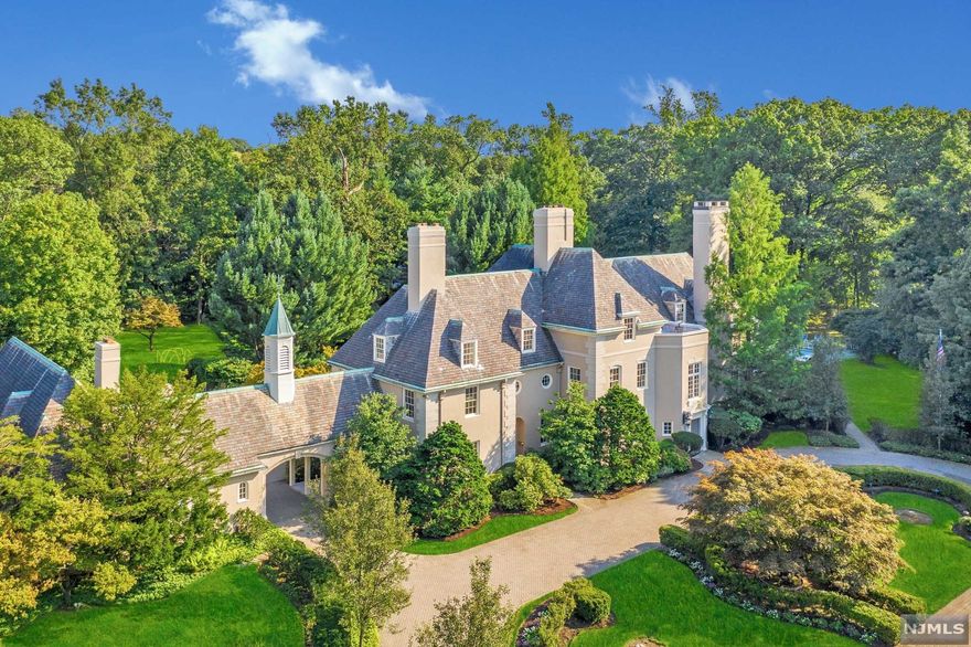 French Chateau inspired mansion, hidden on three park-like gated acres, with meticulous grounds and resort like amenities. The gated entryway is impressive with elaborate herringbone driveway, leading to a 3-story, 20 room residence with approximately 12,000 square feet of living space and additional attached 3 bedroom carriage house. The entry foyer sets the tone for luxury throughout with spectacular rooms for entertaining, yet is also the perfect balance for todays casual family living. Located near a nationally ranked K-12 private school, Englewood's fine shops, restaurants, and only minutes to NYC. This compound will appeal to the buyer requiring absolute privacy, a lover of tranquility, and an appreciation for the finest craftsmanship.