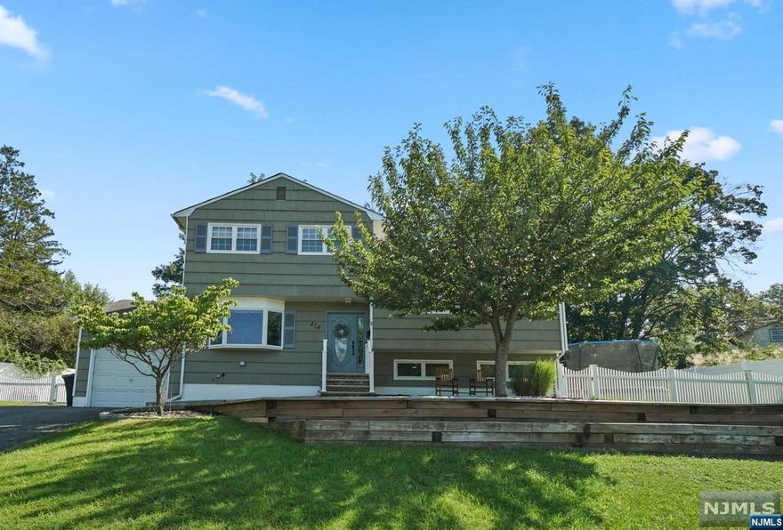 Charming 4 bedroom 2 full bath expanded Tri level split in an idyllic suburban oasis. Top Tier School System & tranquil streets make this town a cherished choice to set roots. This home boasts 4 levels of spacious living: Lower level play room, office and laundry room. Main floor: large entry with double closet, full dining room with bay window, gorgeous chefs kitchen with Quartz Countertops, steel appliances including whirlpool double oven. The kitchen is open to a cathedral ceiling family room or dining room (addition) overlooking spacious patio and yard. Full bath also on this level. Upstairs a beautiful living room, another full bath and four bedrooms. Very flexible Floorplan. Furnace age 2018, A/C System 2019. located approx 4 blocks to K-8 school and NYC bus stop. Come explore, you wont want to leave.....