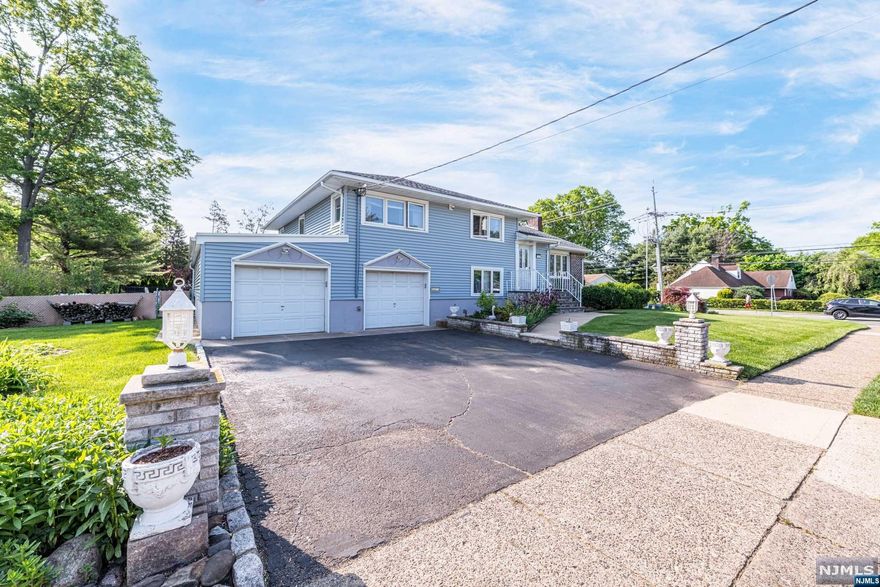 Located in the desirable Montclair Heights with 4 levels of living space and stunning wood floors on 2 levels, this home offers a warm & inviting vibe w/great entertaining space. The 3-season room provides a versatile space for enjoying the outdoors in comfort. The meticulously landscaped lawn, along w/lush perennial gardens surrounds the entire house, creates a serene & visually appealing environment & includes grape vines & fruit trees! The 2 garages can potentially host 3 cars! NYC bus is across the street & a short drive to MSU, Garret Mountain Reservation, Brookdale Park, Upper Montclair, close to all major hwys: Route 3, 46, 80, GSP & just steps from PS#16. Features include central a/c, furnace 2010, newer hot water heater, wifi-controlled irrigation, security system, brand new wifi auto garage opener, gas heat, wifi auto garage opener, natural gas h/u for grill, remote control ceiling fans, recessed lighting, wood-burning fireplace, paver patio, fenced in yard area & more.