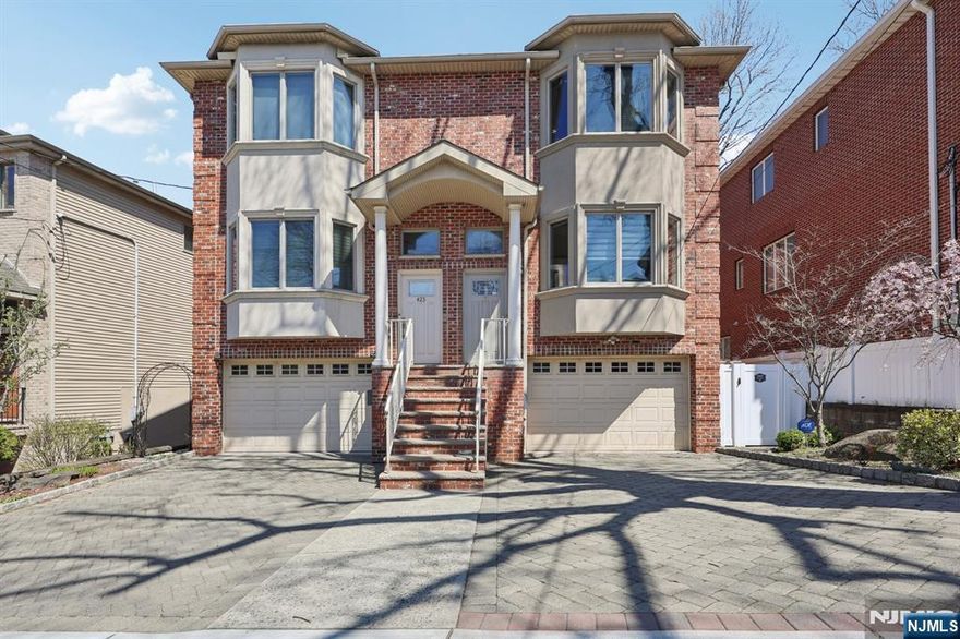 This beautifully designed luxury duplex is ideally located in one of the most desirable areas of Cliffside Parkâ€”perfect for families seeking comfort and convenience. No detail has been overlooked in the construction of this elegant home, featuring 3 spacious bedrooms, 2 full bathrooms, and 2 half baths. The home boasts hardwood floors throughout, high ceilings, and tasteful chair molding on both the first and second floors. The open-concept layout offers a warm and inviting family room with a fireplace, seamlessly connected to a generously sized, high-end kitchen typically found in premium homes. Upstairs, youâ€™ll find the conveniently located laundry area, along with a stunning primary suite complete with a beautifully appointed en-suite bathroom. The fully finished basement features 9-foot ceilings and an additional bathroom, providing ample extra living space for recreation, work, or guests. Additional highlights include an attached one-car garage, a private backyard perfect for relaxing or entertaining, and thoughtful recent upgrades: an EV charger has been installed, a smart thermostat adds modern efficiency and comfort, and a two-zone heating system ensures personalized temperature control throughout the home. Window blinds were installed last year, and the water heater was replaced last year and comes with a 10-year warranty. This is truly a must-see home!
