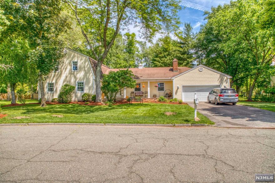 Welcome home to this 5 bedroom, 3.5 bath expanded ranch set on amazing half acre professionally landscaped property. Located on a beautiful tree-lined street with great curb appeal and lemonade front porch. The formal dining room is ideal for entertaining featuring a modern eat in kitchen. Convenient first floor laundry! The heart of the home is the family room with wood burning fireplace, built-ins, beamed ceiling and a large picture window. A first floor master bedroom has 2 closets and a large full bath. The second floor has 2 large bedrooms, and full bath. Great for extended family! The lower level has a rec room, high ceilings. Close to top rated schools and NYC transportation.