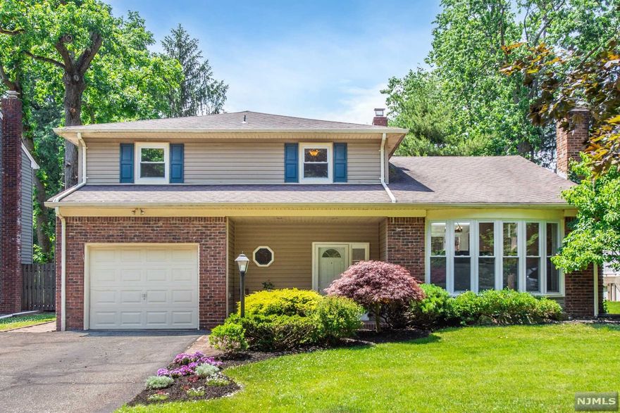 Back on Market! DO NOT MISS this beautifully updated split level home across from Green Acres! Enter this meticulously maintained home & be greeted by a peaceful living room oasis w/ elegant fireplace mantel, open floor plan from dining room leading to the stunning eat-in kitchen boasting crisp white cabinetry, stainless steel appliances, granite counters w/ breakfast bar & sliders to the expansive deck & park like fenced back yard. Upstairs features hall bath & 3 ample bedrooms, including a main w/ sought after en-suite full bath. The ground level will amaze w/ a sun-drenched rec room, convenient powder room, space for a home office (or potential 4th bedroom) & walkout sliders leading to the sprawling patio perfect for outdoor living. Updates abound: wood floors, skylights, pull down storage attic, newer washer/dryer/hot water heater/furnace/central air. W/ EZ access to NYC transportation, schools, restaurants, shops, parks & roadways. LENDER MAY REQUIRE FLOOD INSURANCE.