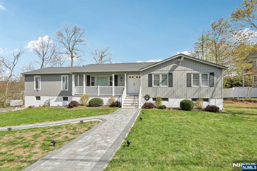 Beautifully updated 4BR, 3BA ranch in the desirable Lake Forest section of Lake Hopatcong. The home features an inviting open front porch, and a flexible layout with multiple living zones, ideal for anyone needing additional space or privacy. or anyone needing extra space. The first floor offers an updated kitchen, dining room with access to the deck, a spacious living room, laundry connections, an updated hall bath, and a private primary suite with its own updated bathroom and separate sitting room with fireplace. Three additional bedrooms and second full bath complete the main level. The walkout lower level expands the living space with a large rec room, a bonus room with walk-in closet, newly renovated ensuite bathroom, and direct access to an impressive 4-car tandem garage (2-car wide opening). perfect for hobbyists, storage, or workshop needs. Major mechanical upgrades include newly connected natural gas, a new direct-vent hot water heater, new forced hot air heat and central AC, plus a dual-head mini-split system serving the finished basement rooms. A rare combination of updates, space, and garage capacity in a sought-after lake community move-in ready and packed with value. Exterior painting is in progress.