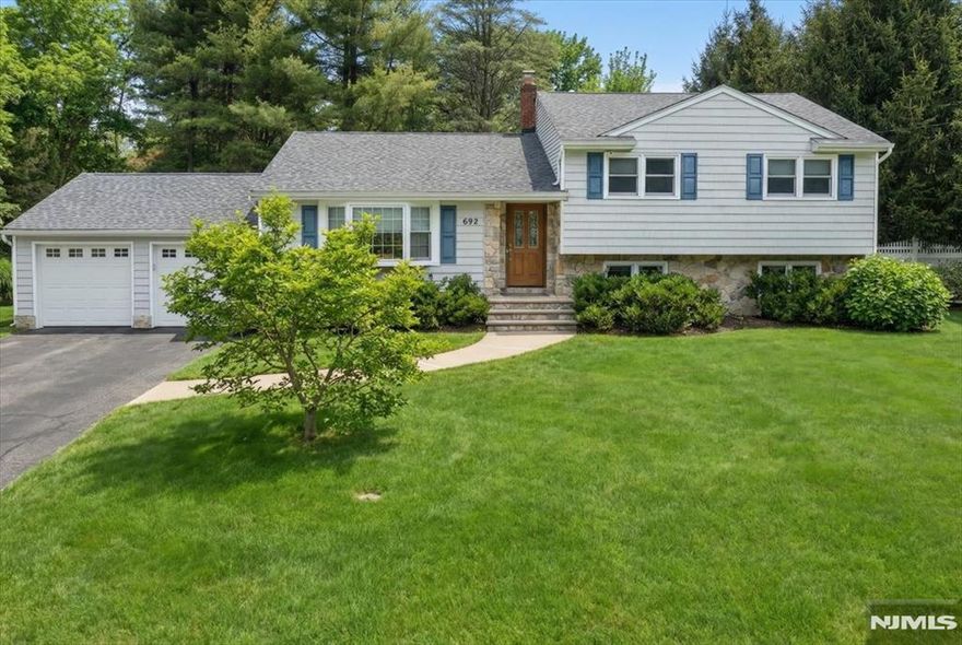 Beautifully updated home tucked away on a quiet, tree-lined street. This thoughtfully renovated property offers a perfect blend of comfort, style, and convenience. The main level features a bright, open layout with a spacious living room, sun-filled dining room, an updated kitchen with modern finishes, and a fully renovated bath. A door off the dining area leads to a Trex deck overlooking the beautifully landscaped, fenced-in yard. The second floor includes three generously sized bedrooms with excellent closet space and an updated full hall bath. The ground level offers a welcoming family room, laundry room, an open office space, and abundant storage. The finished basement provides even more living space along with a separate utility room. Located near major highways, shopping, top-rated schools, and NYC transportation. Come experience the lifestyle youâ€™ve been waiting for. This one won't last.