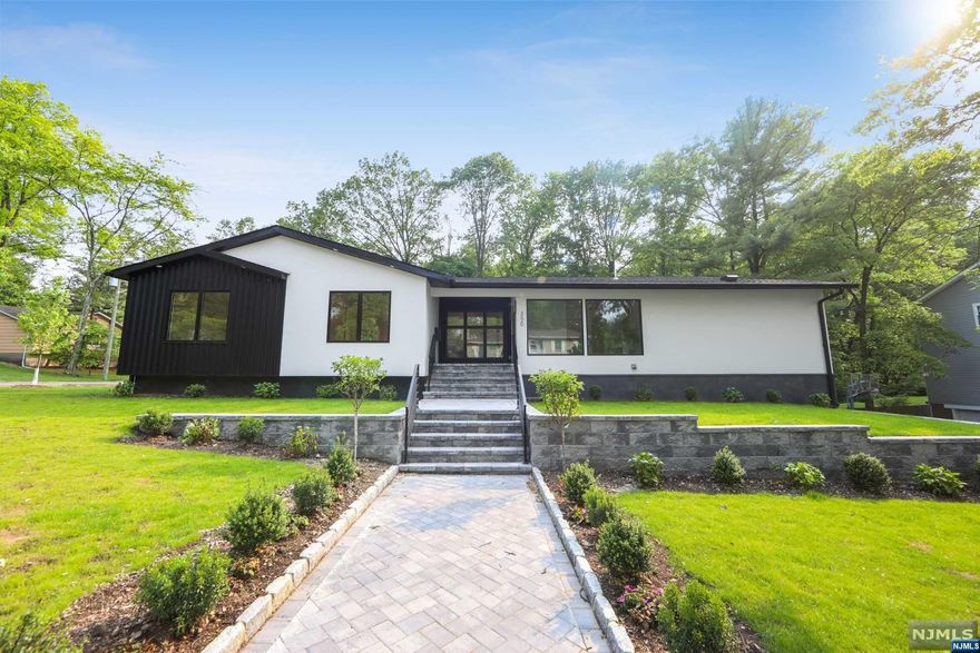 Welcome to this stunning 5 bedroom 4 bath ranch-style modern contemporary home with sleek lines and high end finishes nestled on .37 acres within the East Hill of Englewood.As you step inside, you'll be greeted by an abundance of natural light that filters through the large floor-to-ceiling windows. The foyer leads to a spacious open-concept living area, with minimalist design and clean lines The expansive great room boasts soaring ceilings, a stunning dual fireplace, open to the dining room and outdoor deck designed for effortless entertaining. The gourmet kitchen is a chef's dream, featuring top-of-the-line appliances, sleek cabinetry, quartz countertops and a large island. The luxurious primary suite with the spa like bath with soaking tub and walk in shower. Three additional bedrooms and 2 full bathrooms complete the first floor. The lower walk out level includes a recreation room, bedroom, full bath, laundry,2 car garage. Embrace refined living in this exceptional home .