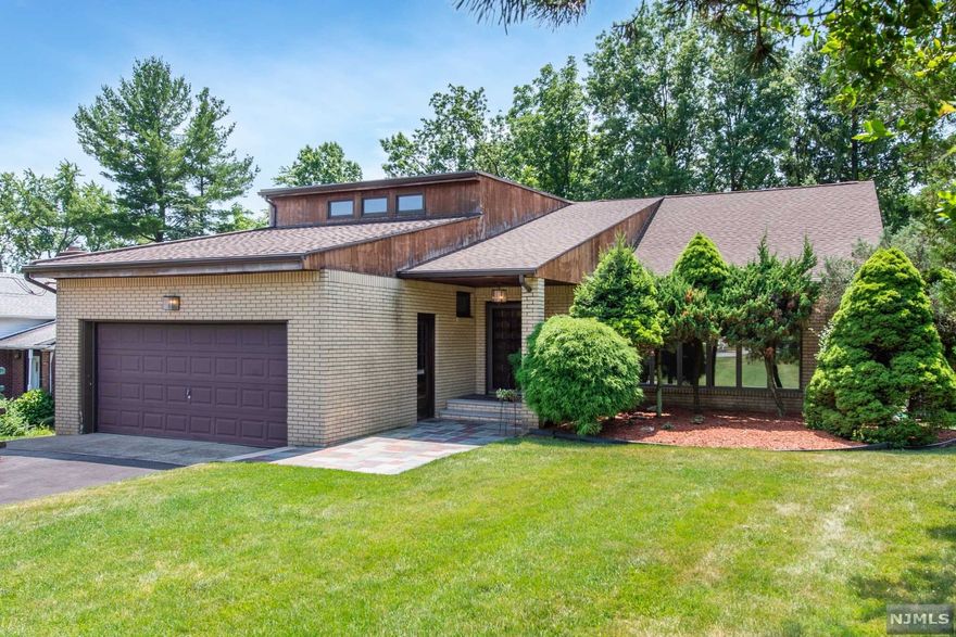 Elegant expanded split-level home located in premier Montclair Heights neighborhood offers 5 bedrooms & 4 full baths. The ground level is ideal for a home office or in law suite with separate outdoor entrance making this home a great opportunity to customize for your needs and add your personal touch. This well-maintained custom home offers spacious light filled rooms with open floor plan foyer with high ceilings, floor to ceiling windows, formal dining room, expanded eat in kitchen with stainless steel appliances and breakfast nook. Entertain or just relax in the oversized family room on the ground level overlooking the landscaped yard and offering the 5 th bedroom or home office with en suite full bath laundry room and access to patio for outdoor enjoyment. There are two master bedrooms both with ensuite baths one peaceful master bedroom is located on the 3rd level offering privacy. There is additional living space in the finished basement recreation room.