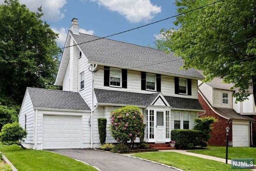 Location... Location...Commuters Dream..!! Welcome to this Move In Ready Colonial Home that has been meticulously and lovingly cared for located on a pretty tree lined street. Approximately 1567 Sq.Ft. . Entry vestibule to spacious living room w/fireplace, dining room w/built-ins and beautiful hardwood floors. Updated eat-in kitchen and powder room. Upstairs three bedrooms and updated full bath. Lower level is partially finished, laundry & utilities. Updated Windows, Roof approx. 5 yrs, attached one car garage w/remote, nice backyard w/patio area. Close proximity to highly rated schools, parks, shops & New York entertainment.. Close to all major highways including GWB,Rt 80, 95, Rt 4, & more and convenient bus routes to NYC..