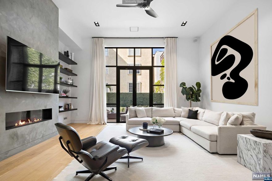 Exceptional and rare 23' wide, 4 bedroom 4.5 bathroom lofted single family townhouse in ideal downtown location with garage parking and three separate outdoor spaces. Entering this beautifully renovated townhouse through a foyer of Terrazzo Renata tile by Ann Sacks leads to a stunning lofted split-level living area with 14' ceilings. Anchoring the incredible living room is a floor-to-ceiling Roman Clay feature wall with 60' linear gas fireplace by Spark Modern flanked by custom shelving. Located just off the living area is the perfect powder room with a Toto Neorest toilet. This jaw dropping space has an abundance of light through 12' windows and a custom 9' patio door which leads to a large custom Ipe deck that leaves plenty of room for outdoor entertaining and includes a dedicated gas line for the BBQ. The custom gourmet kitchen is an exquisite example of modern design by Scavolini with Dekton by Constantino waterfall countertops and fixtures by Dornbracht. The appliance...