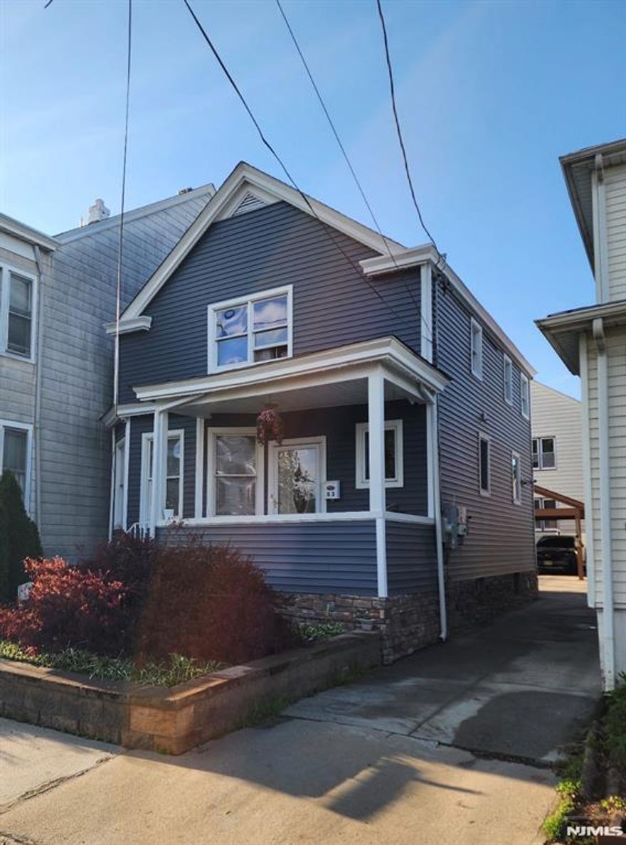 This beautifully updated three bedroom, one-and-a-half bath home in Haledon features an inviting front porch that warmly welcomes you inside. The modern kitchen is equipped with granite countertops and stainless steel appliances, complemented by a center island that enhances counter space and offers a view of the dining area. The living room radiates warmth and coziness while a convenient half bath completes the mail floor. On the second level, you will find three bedrooms alongside an updated full bathroom, with the primary bedroom boasting a walk in closet. The fully finished basement provides additional living space, ample storage, and a designated laundry area. Adjacent to the kitchen, a deck with a retractable awning, a covered carport, and a Jacuzzi create an ideal setting for relaxation. This property is also equipped with solar panels for enhanced energy efficiency and includes central air conditioning. Please note the driveway is shared.