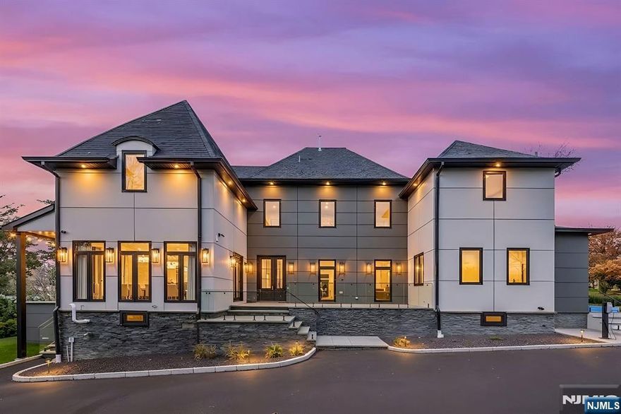 Experience luxury living in this brand-new Modern French Chateau with over 8,500 sq ft of meticulously crafted space across four levels featuring soaring ceilings and exquisite attention to detail. Designed for entertaining, the chef-inspired kitchen boasts commercial-grade appliances, a dramatic 15-foot marble waterfall island, and matching backsplash. The second level offers four spacious bedrooms with spa-like marble baths, custom vanities, and heated floors, while the primary suite provides a private retreat with soaking tub, walk-in shower, dual vanities, and two walk-in closets. A finished attic with vaulted ceilings, automatic skylights, full bath, and lounge area adds versatile space. The fully finished walk-out basement includes an entertainment room, bedroom, gym, full bath, and multiple recreation areas. Outdoors, enjoy professionally landscaped grounds with two bluestone patios an expansive rear patio for grilling and fire pits and a side patio for lounging plus a private rear lawn. Additional features include four-zone central air, whole-house generator, integrated speakers, heated bathroom floors, whole-home water filtration and softener, two tankless water heaters, and detailed custom millwork. Ideally located in Upper Saint Cloud with easy access to top schools, shopping, dining, highways, and NYC transportation.