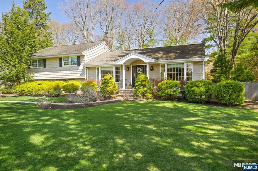 This Remarkable Expanded & Renovated Split Ranch w/soaring ceilings, huge rooms & open floor plan blends the sophistication of Contemporary Elegance w/the convenience of a high end life style. You will LOVE the Incredible deep & wide private property! The Columned Entry foyer leads to the Living Room & Dining Room. The Extraordinary Cathedral Ceiling Kitchen, Great Room & Breakfast Room addition w/fireplace is Beyond Beautiful, and allows for enjoying exemplary culinary cuisine, entertaining, & an incredible Life Style! The Updated Kitchen w/Breakfast Rm, Brkfst Bar, custom Cherry Cabinetry, Granite Counters, & Stainless appliances, opens to the Expansive Cathedral Ceiling Great Room w/fireplace & views of the spectacular rear yard. This incredible design & open floor plan is right out of Architectural Digest, and is truly breathtaking. A hallway leads to the home office/4th BR & Powder Rm. Upstairs is a Primary Suite w/Renovated Primary Bath, 2 additonal Bedrooms & a Beautiful Main Bath. The Ground level off the Kitchen has a large Laundry Area/ Mud Room which leads to the spacious 2 car attached Garage. The Lower Level has a large Recreation Room & lots of Storage. The exceptional rear Yard is remarkable in space and beauty, with paver patio, deck & your own private park. River Vale offers an Easy nyc commute by car, bus & rail, Seasonal Town Farmer's Market & close proximity to fine Restaurants, & the Exceptional River Vale Library. You will LOVE Living Here!
