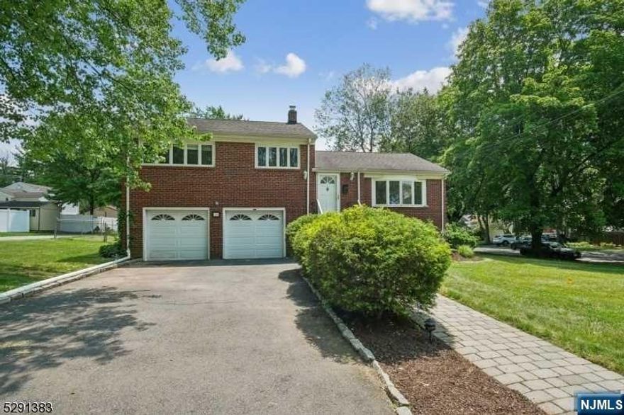 STUNNING direct views of the golf course! This charming brick colonial sits on a large corner lot right across from the golf course in the lovely St. Cloud neighborhood. Beautifully updated, freshly painted and with a 2-car garage, this one is not to be missed. Walk into the charming Living/Dining room with bay windows and gorgeous views. Kitchen with crisp white cabinets, brand new counters and skylight letting in loads of natural light. Spacious Family Room w/ new floors and doors that lead to a massive deck looking out to a large fenced in yard. Few short steps to be greeted by 3 spacious bedrooms & 2 baths. Main bedroom 2/ attached bath. Wood floors throughout. Newer windows! Large finished basement access through 2 car garage. New washer/dryer, dishwasher, refrigerator will be replaced with new one prior to closing. Newer hot water heater. Central air. Location is fabulous. Large property! Walk to Elementary school, parks, NYC transport. Close to all major highways.
