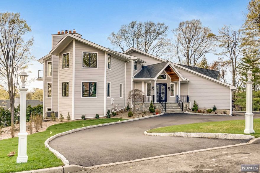 This amazing, completely renovated home leaves nothing to the imagination. All top of the line building materials and appliances. The grand entry foyer opens to a center staircase, beautiful flooring, crown molding, tray ceilings, 4 fireplaces set in granite and/or stone. The main level includes a huge kitchen with SubZero fridge, Zline gas stove, 2 beverage fridges, granite countertops. The dining room flows into the family room with a fireplace, both with hardwood flooring. Step into the formal living room, also with a fireplace, hardwood floors & a wet bar. The laundry room contains a large pantry. The master bdrm has a fireplace, several closets, an enormous walk in closet and a bathroom w/soaking tub. 3 additional bedrms w/ full baths and 1 balcony complete the 2nd floor. The ground floor has a huge entertainment room w/fireplace & 2nd kitchen,2 full baths, two bedrooms both w/ sliding doors onto a patio,leading to a heated pool& hot tub, great entertaining options!