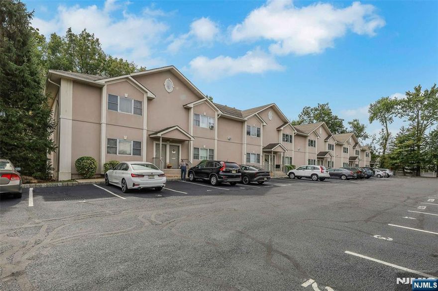 Welcome to Brookside Commons, a sought-after 55+ community in Saddle Brook. This first-floor unit features an open floor plan with a spacious living room, dining area, and kitchen complete with a breakfast bar and plenty of cabinet space. The home offers two generously sized bedrooms, each with its own private terrace overlooking the peaceful rear yard, perfect for enjoying morning coffee or quiet relaxation. An oversized bathroom provides convenient access from both the primary bedroom and the main living area. Additional highlights include central air, forced hot air heat, two designated outdoor parking spaces, and ample guest parking. Ideally located close to major highways, shopping, and with a NYC bus stop right at the corner, this home offers both comfort and convenience.