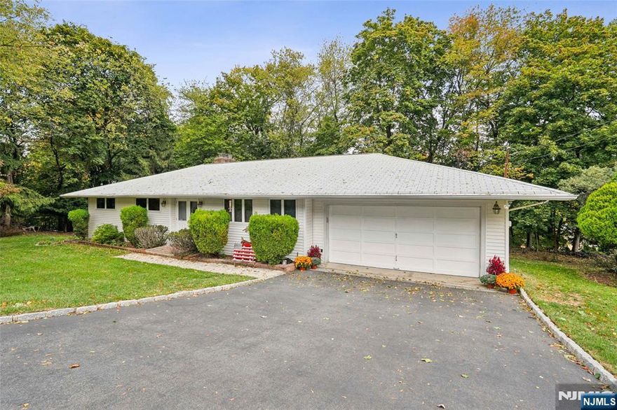 Get ready to make this charming ranch your dream home. Set off a quiet street in Hawthorne NJ, the main entry foyer opens to a large living room with fireplace and dining room that leads to a deck overlooking the yard. The eat-in kitchen is easily accessible from the built-in 2-car garage and a full bath. Down the hall are three bedrooms and a full bath. The master bedroom includes slider doors leading to the deck. A full finished walk-out basement doubles the living space, featuring a family room with fireplace and built-in bar area, an office, rec room, utility room, and storage room. This home comes with a house generator. Great location, right off Goffle Hill Rd near Wyckoff, and close to Rte 208.