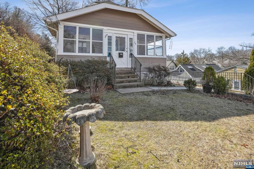 This charming three bedroom, two bathroom home boasts an updated kitchen and bathrooms, complete with modern fixtures and appliances. Hardwood floors run throughout the home, creating a warm and inviting atmosphere. Large windows allow for tons of natural light, creating a bright and airy ambiance. The detached one car garage provides ample space for storage and parking, while an enclosed front porch offers a peaceful retreat for relaxing and enjoying the outdoors. This home is perfect for those who appreciate both classic charm and modern convenience. As is.