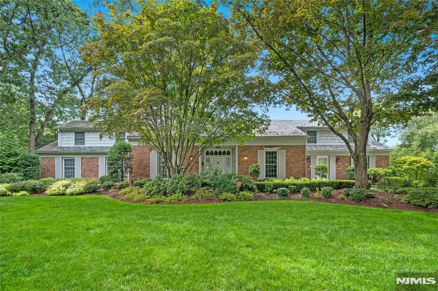 An elegant Upper Montclair custom home offering refined living and exceptional scale, set on a lushly landscaped three-quarter-acre property designed for both grand entertaining and everyday comfort. This impressive residence features four expansive three-room bedroom suites, including a luxurious first-floor primary suite, along with an additional ground-floor bedroom ideal for guests or multigenerational living. Six beautifully updated full baths and two thoughtfully placed powder rooms provide effortless convenience throughout the home. Generous, light-filled rooms define the main level, including a large eat-in kitchen, richly appointed library, private office, formal living room with gas fireplace, and elegant dining room each designed with timeless proportions and seamless flow. The fully finished lower level is a destination of its own, featuring a spacious family room with fireplace, second kitchen, gym, bedroom, two full baths, and a temperature-controlled wine cellar perfect for recreation, relaxation, or hosting. Outdoors, the private grounds unfold into a resort-style retreat with manicured gardens, stone patios, a custom in-ground pool with cascading waterfall, and an inviting firepit, creating a tranquil setting for gatherings or quiet moments alike. A rare offering that blends classic architecture, modern amenities, and a truly exceptional lifestyle all close to Yantacaw Brook + Brookdale Parks. Upper Montclair Village with its restaurants + shops is close by.