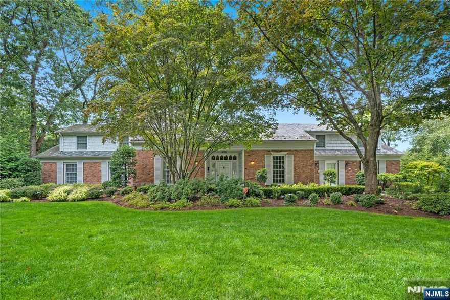 An elegant Upper Montclair custom home offering refined living and exceptional scale, set on a lushly landscaped three-quarter-acre property designed for both grand entertaining and everyday comfort. This impressive residence features four expansive three-room bedroom suites, including a luxurious first-floor primary suite, along with an additional ground-floor bedroom ideal for guests or multigenerational living. Six beautifully updated full baths and two thoughtfully placed powder rooms provide effortless convenience throughout the home. Generous, light-filled rooms define the main level, including a large eat-in kitchen, richly appointed library, private office, formal living room with gas fireplace, and elegant dining room each designed with timeless proportions and seamless flow. The fully finished lower level is a destination of its own, featuring a spacious family room with fireplace, second kitchen, gym, bedroom, two full baths, and a temperature-controlled wine cellar perfect for recreation, relaxation, or hosting. Outdoors, the private grounds unfold into a resort-style retreat with manicured gardens, stone patios, a custom in-ground pool with cascading waterfall, and an inviting firepit, creating a tranquil setting for gatherings or quiet moments alike. A rare offering that blends classic architecture, modern amenities, and a truly exceptional lifestyle all close to Yantacaw Brook + Brookdale Parks. Upper Montclair Village with its restaurants + shops is close by.