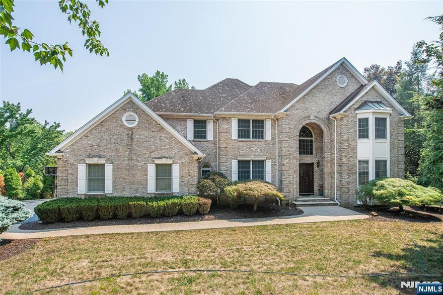 Introducing opportunity! One of the most desirable locations in Wayne township, impressive open floor plan & beautiful private property with inground pool. Welcome Home! Features include: Incredible cul-de-sac location, 2 story foyer w/cathedral ceilings, custom library/office with built in shelving & drawers. Great room w/over 20-foot soaring ceilings, beautiful wall of windows, built in's & fireplace. Gourmet kitchen w/high end appliances, granite counter, pantry & center island w/separate breakfast room. Formal living & dining rooms, first floor laundry room & powder room. Second floor includes: Large primary suite w/multiple walk-in closets, full bathroom w/double vanity sinks, separate shower & jetted tub. 3 Large additional bedrooms w/tray & cathedral ceilings, ample closet space & a huge walk-in storage room & full bathroom. Lower level: Full finished basement w/multiple rec rooms, additional room w/private full bath suite, walk in temperature-controlled wine cellar w/shelving, & storage room. Additional attributes include: Hardwood floors, recessed lighting, & tons of storage. Enjoy the outdoors lifestyle: beautiful private property w/multiple oversized yard areas w/endless possibilities, in-ground pool, paver patio, deck, newer fence, retractable custom awning, water fall & pond. All perfect for large party or a quiet night at home relaxing. Desirable location. Close to shopping, restaurants, top rated school system, major highways & NJ Transit Bus & Train Center.