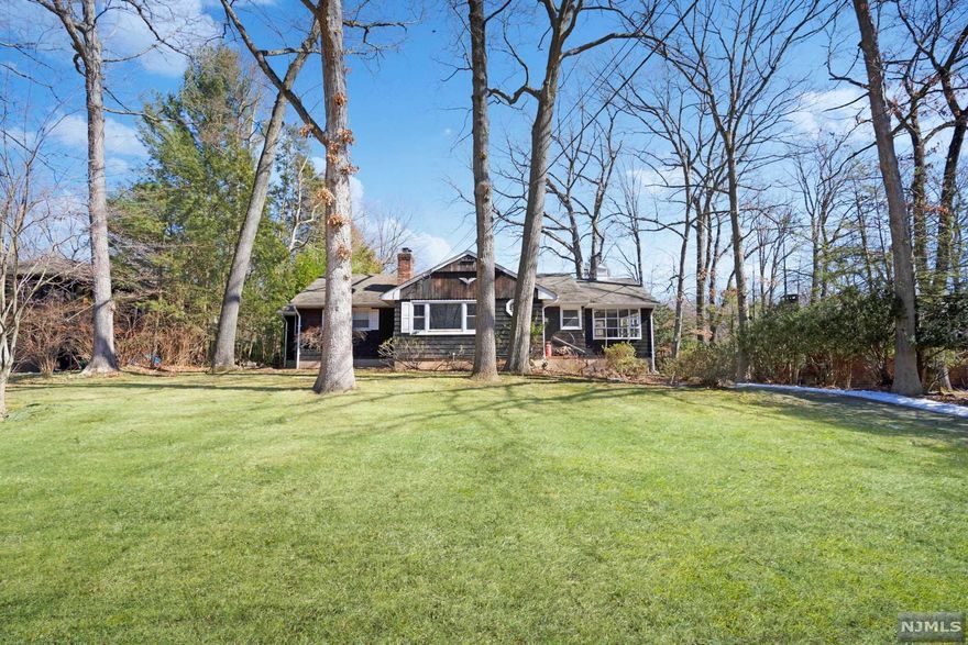 Come see this large ranch in the beautiful wooded area on an extremely large piece of property. This home features 4 bedrooms, 2 full bathrooms, kitchen with all stainless-steel appliances, skylights & pantry + separate dining area, LR with woodburning fireplace, & sunroom complete the main level. Hardwood floors. Finished basement with Rec Room w/wet bar & cast iron woodburning stove, 2nd bath, laundry room, office/BR, & utility room, This home also has a 1 car built-in garage, a large driveway, & underground sprinkler system and an above ground pool. Home does have a functioning oil tank, well and septic system. Home is directly across from the Ramapo Mountain Reservation Hiking Trail. Conveniently located to major highways!