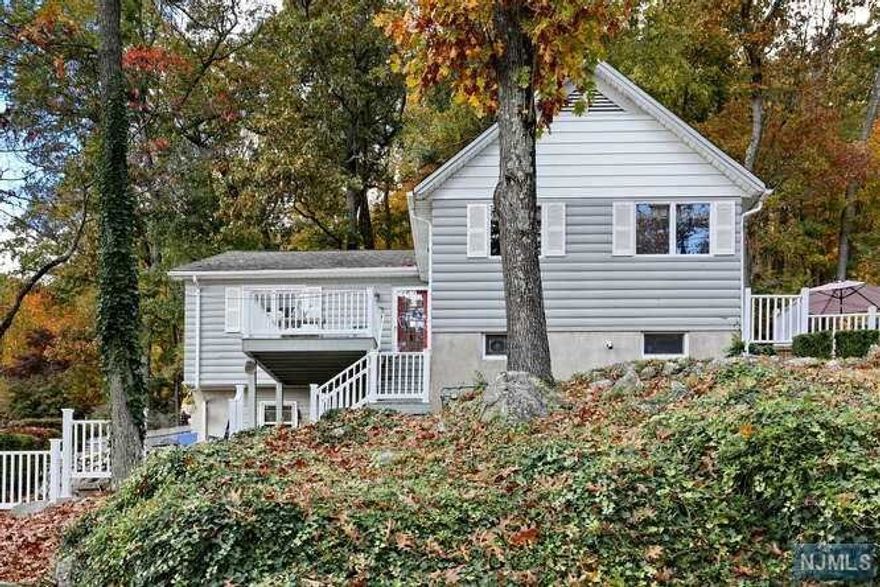 Gorgeous views all day long! This cozy cape cod style home is perched upon a hill overlooking Lake Erskine. Take in the beautiful lake views from the front deck as well as a side patio and front bedroom. Walk up the front deck to the main entrance of the home, or easy access from the driveway through the family room door. Enjoy an open concept kitchen, dining and living room with fireplace, as well as a door leading to the side patio. Back inside, head through the living room and you will find a Master Bedroom w/full bathroom, 2 good sized bedrooms as well as another full bath. The downstairs family room is a cozy place to unwind. Main floor laundry, Central Air, Generac generator. This home has been meticulously cared for and shows pride in ownership. Park and Ride is 1 mile away, w/express bus to Port Authority. Lake, recreational activities, library, schools, houses of worship, are all close by. You will not want to miss the opportunity to live in this amazing lake community.