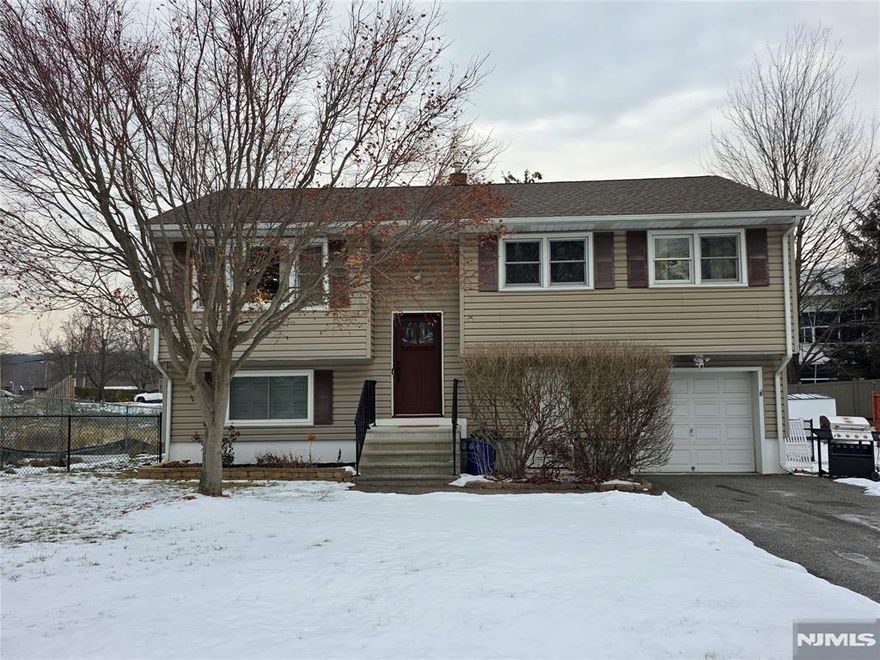 Beautiful 4 Bedroom 2 Bath Home in the heart of Denville. This Bi Level boasts hardwood floors and a great open floor plan. Large deck off the kitchen leading down to beautiful new paver patio and gorgeous, level fenced in yard. There is large driveway perfect for multiple cars and plenty of street parking as well. It is located on a beautiful street and walking distance to the desirable Denville Downtown Area. The Perfect Location! Easy access to public transit and houses of worship. This home has been well maintained and updated throughout the years including a new roof and new windows. Desirable Denville at a great price and low taxes. Move right in