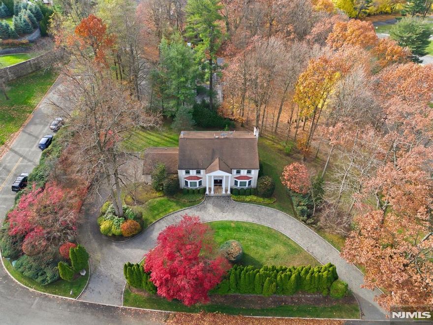 Fabulous all brick center hall colonial originally built by the master builder, Joseph Di Staulo, and perfectly situated in the prestigious Tammy Brook Hills Estate. Upon entering, you are greeted by a grand two story entrance hall with a sweeping bridal staircase, timeless architectural details, and elegant finishes throughout - including a circular driveway, Chevron patterned flooring, custom hand painting, and numerous refined features. The first floor offers a banquet-sized formal dining room, an expensive formal living room, and a custom modern kitchen featuring cherry cabinetry, granite countertops, and top-tier appliances overlooking the private backyard, a spacious family room with a fireplace, a powder room, and a convenient laundry room complete the main level. The second floor features a beautiful primary suite with a resort-like bathroom, along with three generously sized bedrooms and a hallway bathroom with double sinks. The walkout basement is thoughtfully designed with a large recreation room, a wet bar, a bedroom with its own bathroom, an additional full bathroom, and a summer kitchen. Enjoy picturesque, year-round views through large windows in this exceptional Colonial residence.