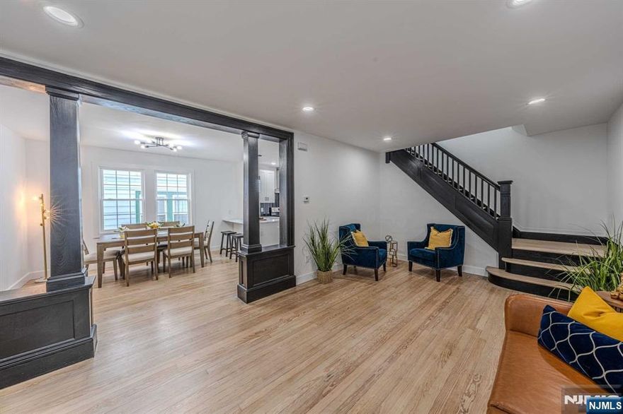 Step into this fully renovated 4-bedroom, 2 1/2 bath home, where contemporary design meets everyday comfort. The striking black-and-white aesthetic throughout the home adds a timeless, modern appeal. The main floor offers a versatile layout, including a spacious bedroom that can double as a home office or guest room. The open-concept kitchen seamlessly connects to the dining room, perfect for hosting and everyday family life. The kitchen features sleek countertops and ample cabinetry, making it as functional as it is stylish. Upstairs, you'll find the master suite, complete with a private en-suite bath. Two additional generously sized bedrooms share a stylish full bath on this floor. Outdoor living is equally impressive with a large deck and backyard. Located in an ideal spot for commuters, this home offers quick and easy access to New York City, blending the best of suburban living with urban convenience.