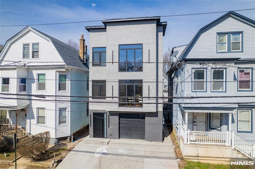 A statement of sophistication and craftsmanship, this custom new-construction two-family residence redefines modern living in Irvington, NJ. Designed with an emphasis on natural light, open flow, and contemporary elegance, every element of this home exudes refinement. From the 9-foot ceilings and gleaming hardwood floors to the European windows and designer tile-work, each detail has been curated for comfort and style. The chef's kitchen showcases quartz countertops, premium stainless-steel appliances, and a stunning center island perfect for entertaining. Step into the primary suite complete with a walk-in closet and spa-inspired bath. The versatile lower level provides ample additional living space, ideally for recreational room, media room, yoga room the options are endless, additional half bath, laundry, and access to an oversized garage. All this at a value that is truly unmatched in today's market. Incredibly low taxes and 5 year benefits apply. Conveniently located close to parks, shops, eateries, NYC commute, & so much MORE!