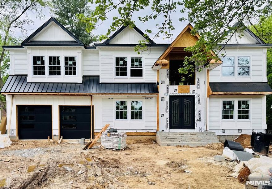 This stunning new construction, crafted by a highly regarded local builder, is nestled on one of Paramus's most sought-after streets. Offering approximately 5,000 square feet of luxurious living space, this exceptional home features 5 bedrooms and 6.5 full baths, built upon an existing foundation with soaring 9-foot ceilings. The first floor includes a versatile En-Suite bedroom perfect for guests or extended family. Upstairs, the second floor showcases a grand primary suite with a spa-like bath and spacious walk-in closets. 3 private En-Suite Bedrooms along with additional bedroom and hall full bath. Designed for elegance and comfort, the home boasts a dramatic two-story entry, an open-concept layout, stunning coffered ceilings, custom millwork, a gourmet kitchen, and rich hardwood floors throughout. The fully finished basement offers additional 1000 sq feet of living space, living space, a media room, & full bath.