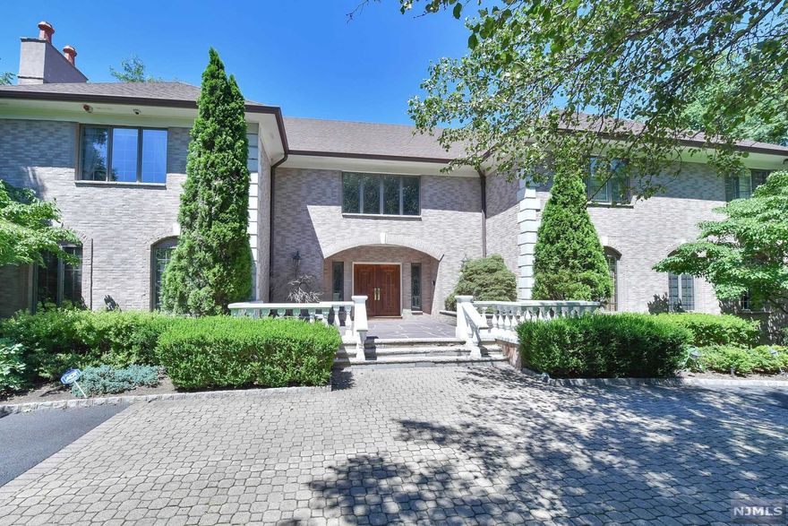 Both pool and tennis on this prime 2 acre, hilltop setting in sought after Burning Hollow surrounds this gracious and elegant 6 bedroom, brick colonial manor. Two story entry with double bridal staircase sets the tone for this wonderful residence. Beautiful woodworking, high ceilings, finished w/o lower level, 2 fabulous wine cellars for the avid collector and a 5 car garage are just a few of the numerous amenities and features. Tennis court needs resurfacing & is being sold in "as is" condition. Close proximity to New York City.