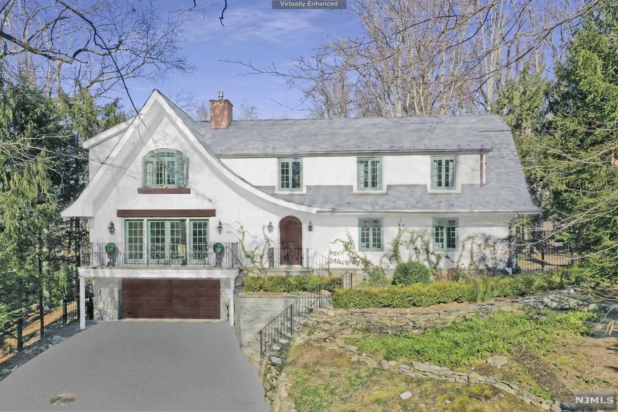 This enchanting, story book residence has been completely & beautifully renovated recently with state-of-the-art finishings and details throughout. The elegant front to back entry foyer leads to a large living room with fireplace and built-ins, opening to a gracious dining room with access to the rear yard. The fully updated gourmet kitchen features Miele, Wolf and Thermador appliances, has banquette seating and a large pantry. The 1st floor bedroom w/full bath also doubles as an office for working remotely. The 2nd floor offers a primary bedroom with fireplace/tray ceiling/3 walk-in closets and luxury bath with floating tub. 2 additional bedrooms each have a private full bath. There is a finished basement, 2 car garage, rubberized slate roof, inground pool, cabana w/large living room/fpl, kitchenette, full bath and basement, pergola. Elevator to all 3 levels of the main house. Sought after Chestnut Ridge area of Saddle River!