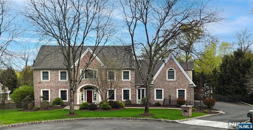Beautiful 5-Bedroom, Custom-Built Colonial Brick Home Located at the end of Quiet Cul-de-Sac in Sought-After Fardale Section of Mahwah. 2-Story Grand Foyer with wainscoting and over 7,000 square feet of living space. Features include two staircases and hardwood floors throughout the 1st and 2nd levels. The first level includes an Old English Pub room with gas fireplace, Office/Den, Great Room with cathedral ceilings, gas fireplace, and a wall of windows with backyard views. Formal Dining Room is just off the gourmet Kitchen featuring granite countertops, paneled and stainless high-end appliances, island, and large dining area. Also on the first floor: Laundry Room, two Powder Rooms, and a Mudroom leading to the 3-car garage.The second floor offers a Master Bedroom Suite with spacious Primary Bath and 2 walk-in closets. There are four additional large Bedrooms, all with hardwood under the carpet, and two Full Baths.The Finished Walk-out Basement includes a built-in bar, Media Room, Billiard Room, gym, second Family Room, Game Room, Half Bath, Workshop, and storage. A multi-level outdoor entertaining area with Trex deck off the Kitchen and Great Room leads down to a paver patio with gas firepit overlooking the Resort-like Heated Gunite Pool with new tile and coping, and professionally landscaped property. Additional updates include a new roof, gutters, shed, and updated bathrooms. Live in your own Private Resort just in time for summer!
