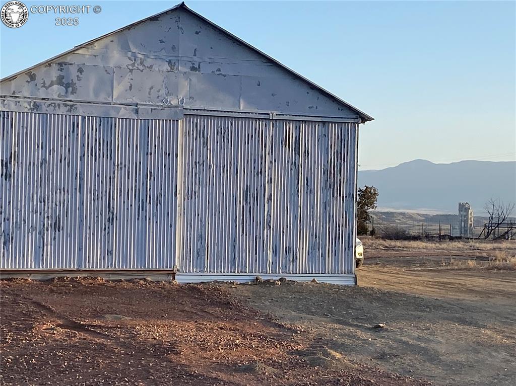 View of outbuilding with a mountain view and an outdoor structure