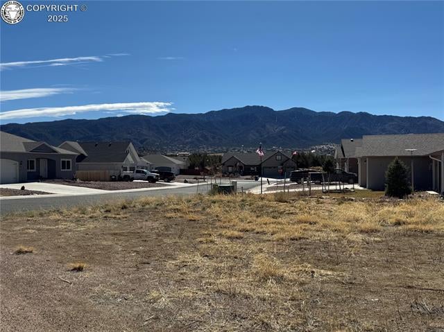 Property view of mountains with a residential view