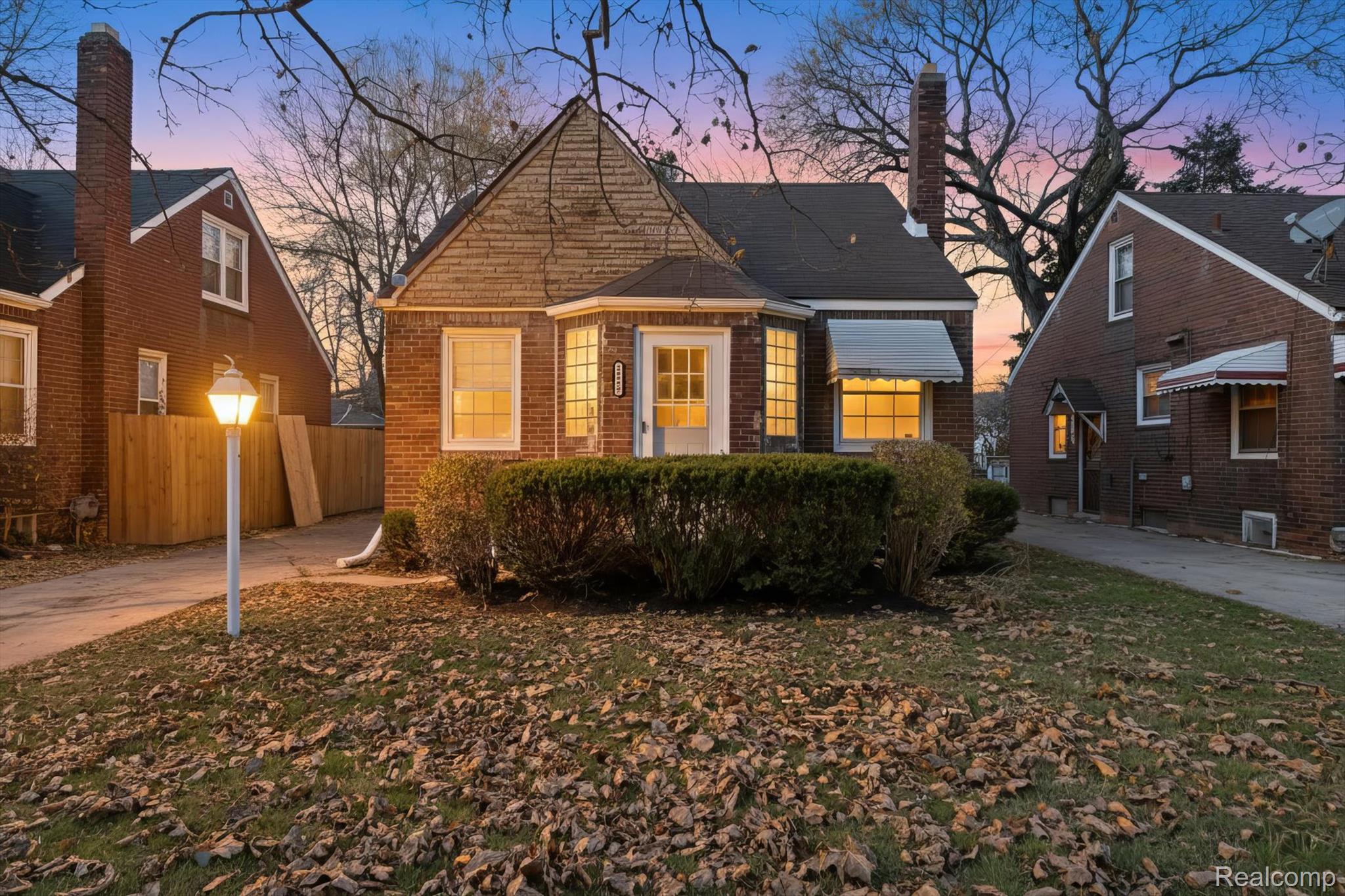 Bungalow-style home with a chimney and concrete driveway