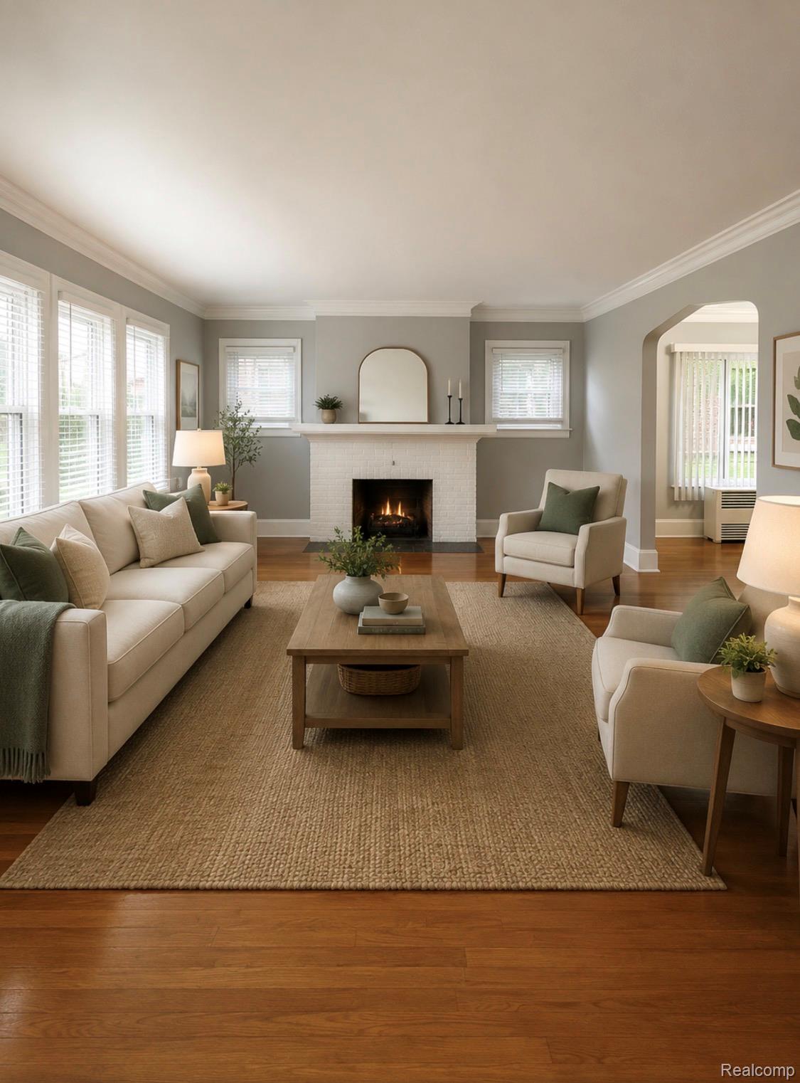 Living area featuring wood-finish flooring and a white brick fireplace with a mantel