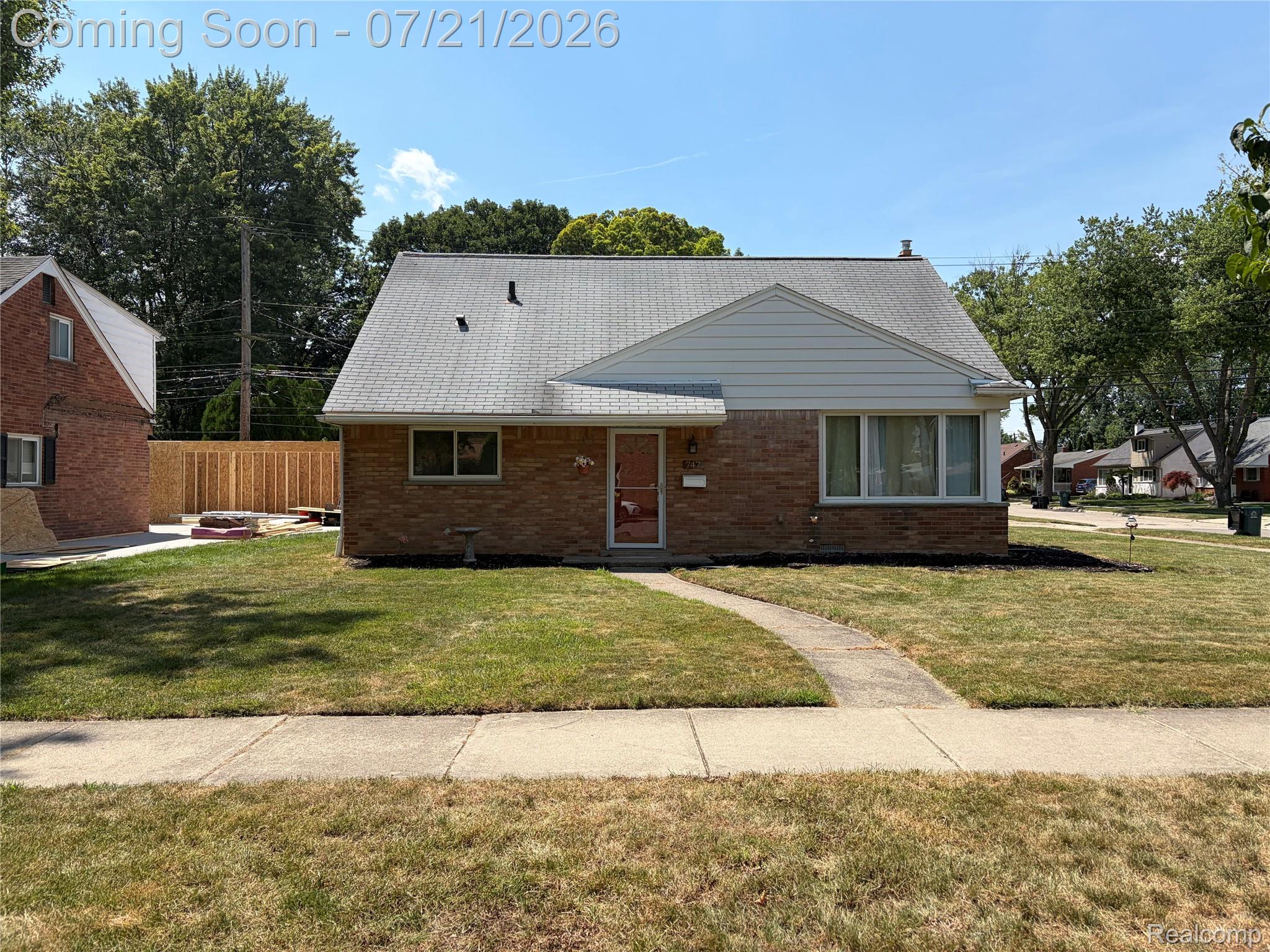 Brick and siding exterior with a light gray shingle roof