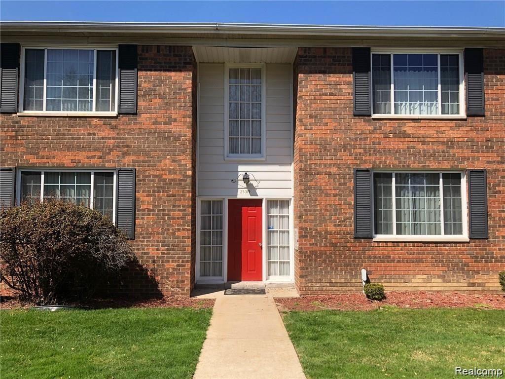 Brick facade with contrasting white siding around the entrance