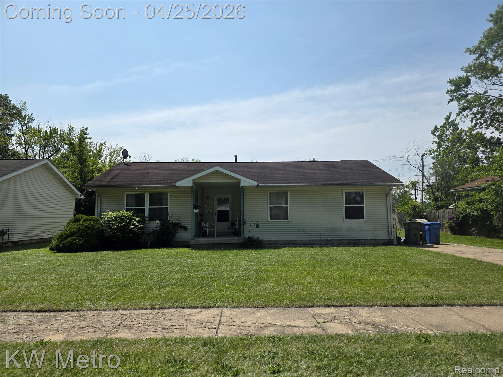 View of front of home with a front lawn and covered porch