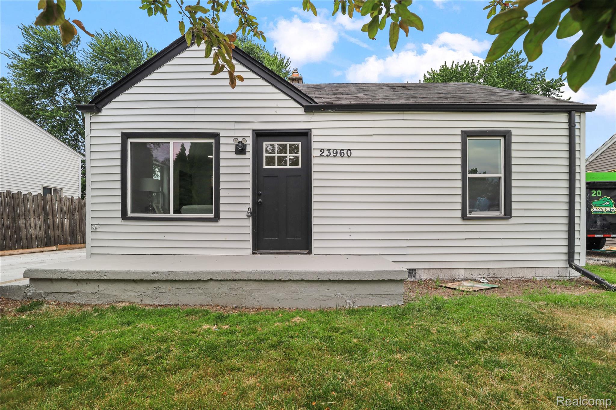 Light-colored horizontal siding exterior with dark trim