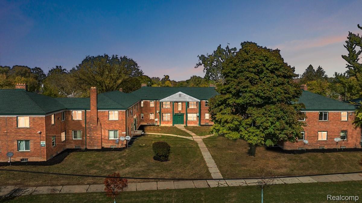 View of front facade with a front lawn and a chimney