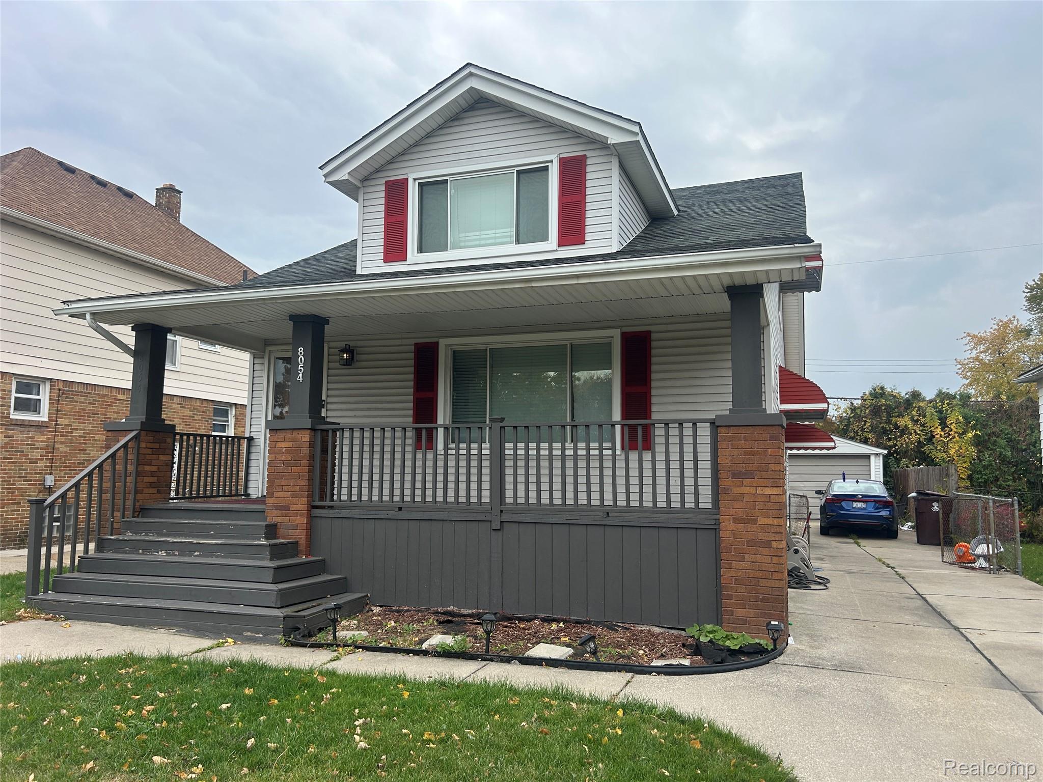 Bungalow-style home with covered porch and roof with shingles
