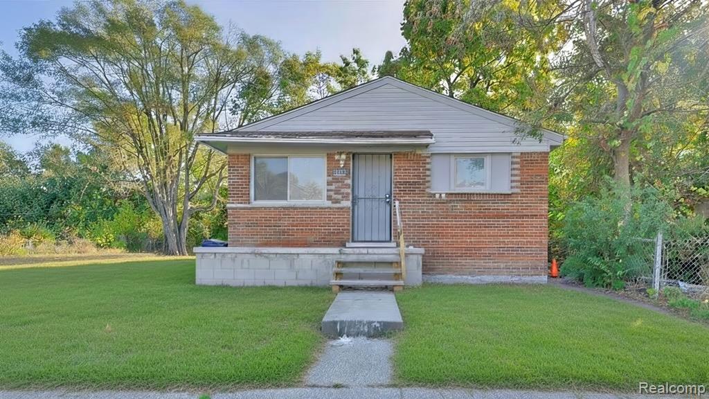 Brick exterior with light-colored siding, a concrete walkway, and a small front porch featuring concrete steps