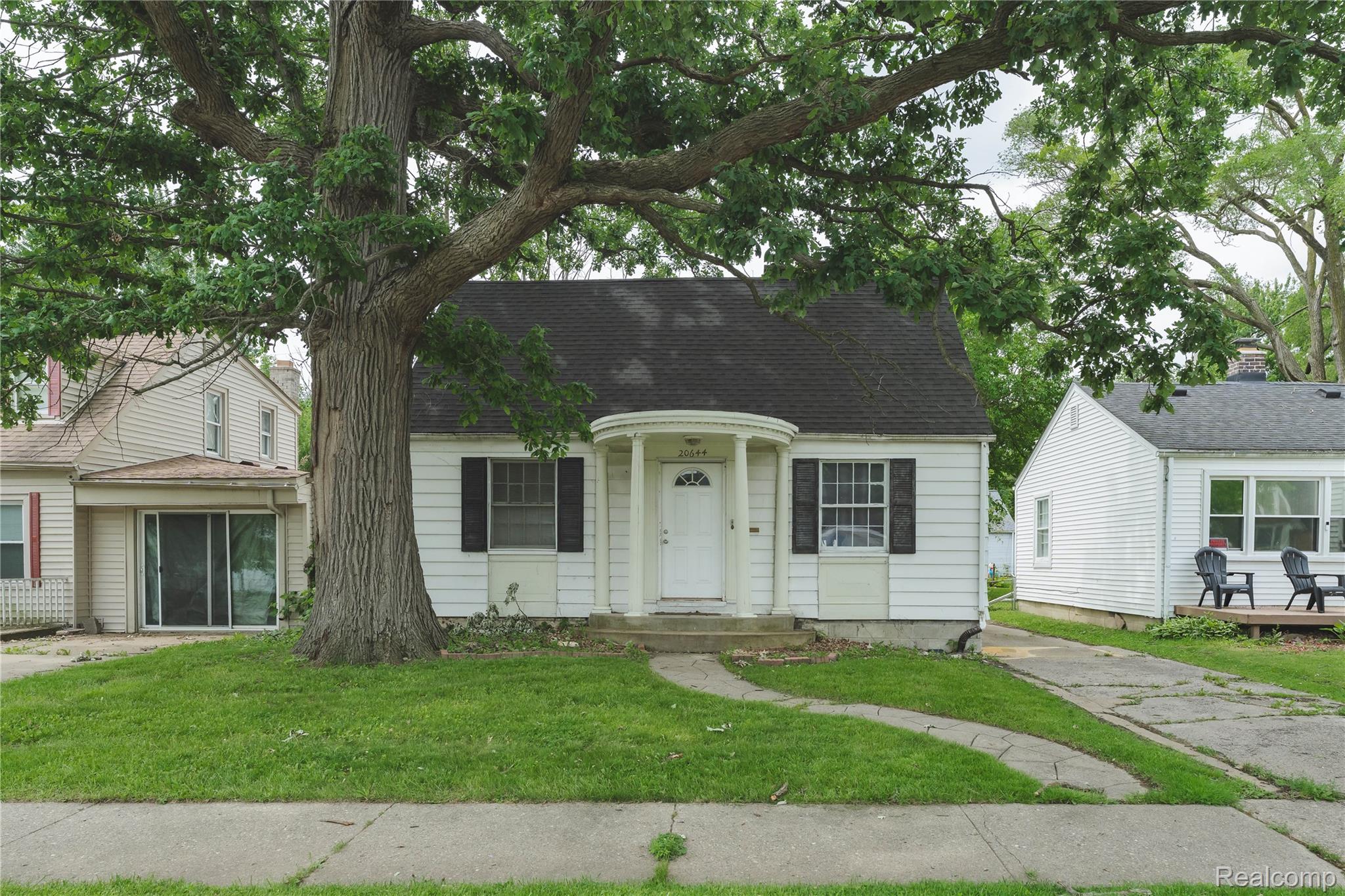 Traditional single-story residence with a prominent mature tree